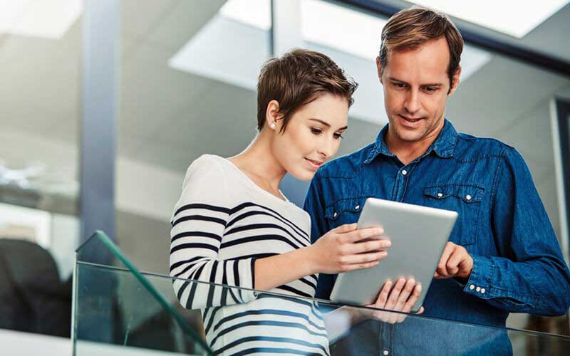 Two users looking at tablet device