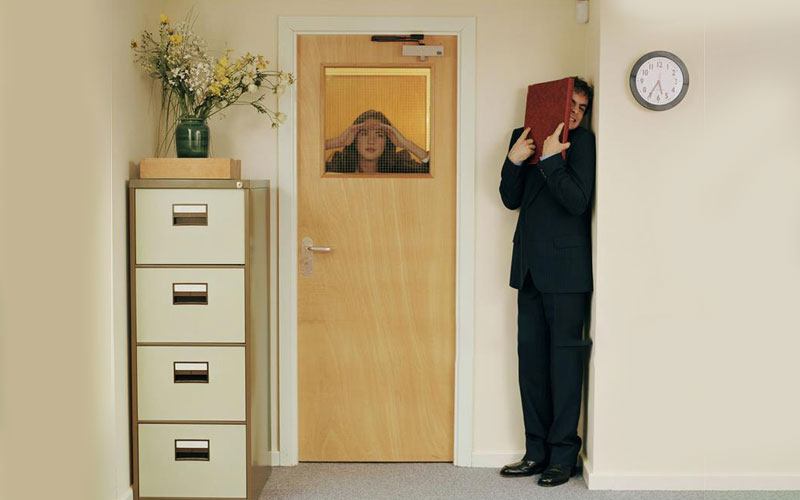 Man hiding in a corner