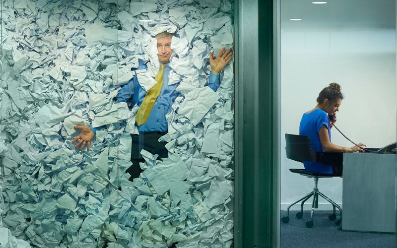 Man surrounded by paperwork