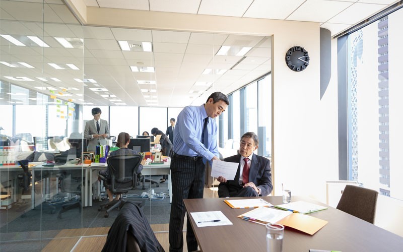 IT solutions for industry expertise Two men in meeting room discussing