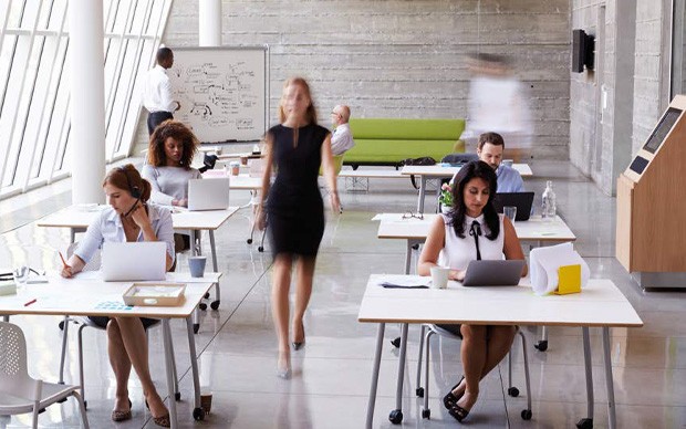 Empower your business Woman walking through an open plan office