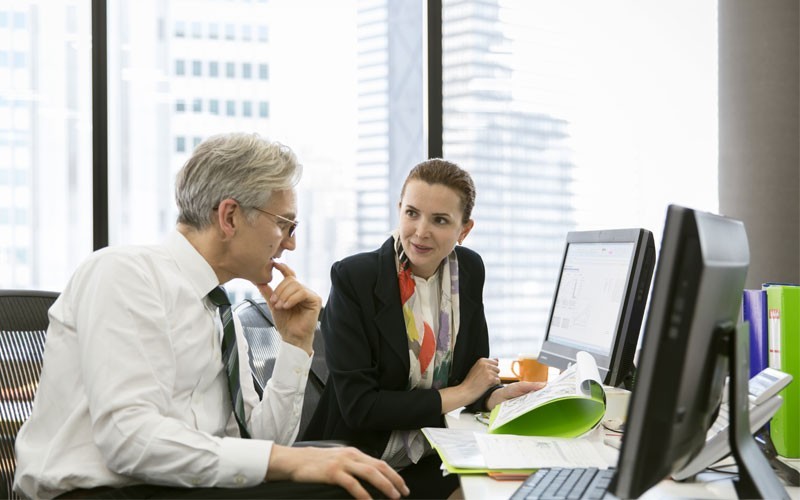 HPE technology solutions for every industry two business employees discussing at desk