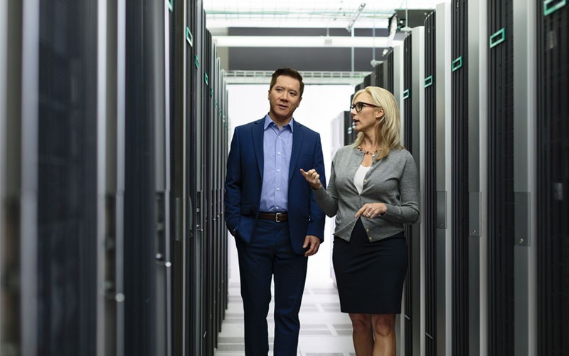 Advanced data storage and servers Two employees walking through server room
