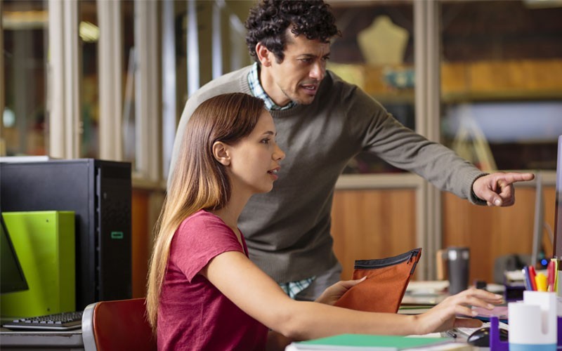 IT networking solutions for your organization Employees collaborating in front of desktop