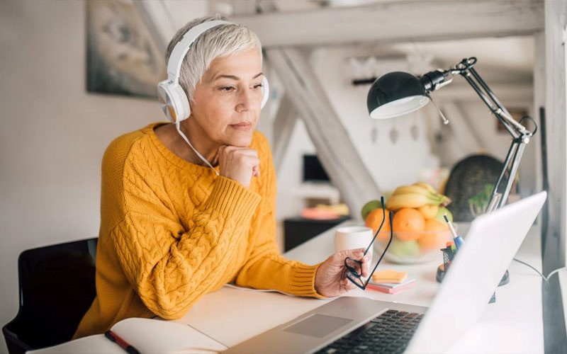 Experience connectivity and availability through security best practices Woman working on laptop while wearing headphones