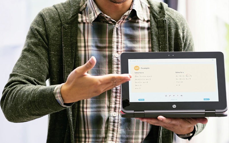 Trade-in devices to get the most for your students Teacher holding a HP device