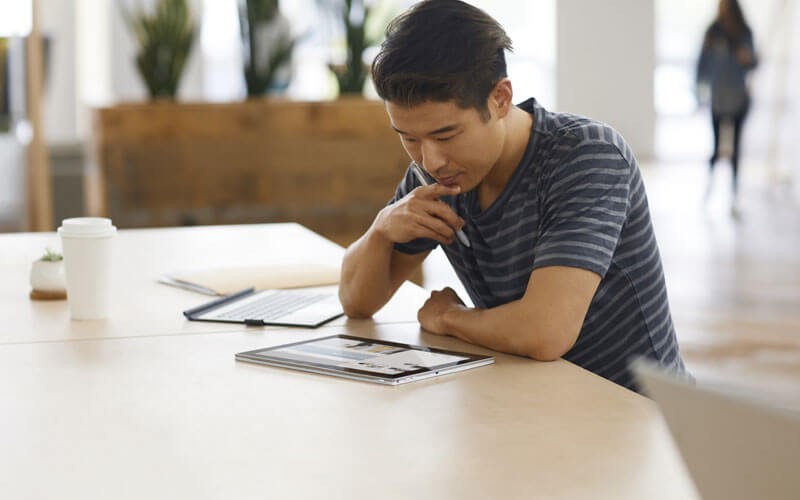 HP personal computers Young man working on 2-in-1- HP notebook device