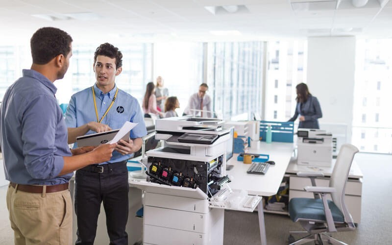 Manage your printers with HP Managed Print Services Printer technician checking the HP Color LaserJet Enterprise Flow MFP M577z