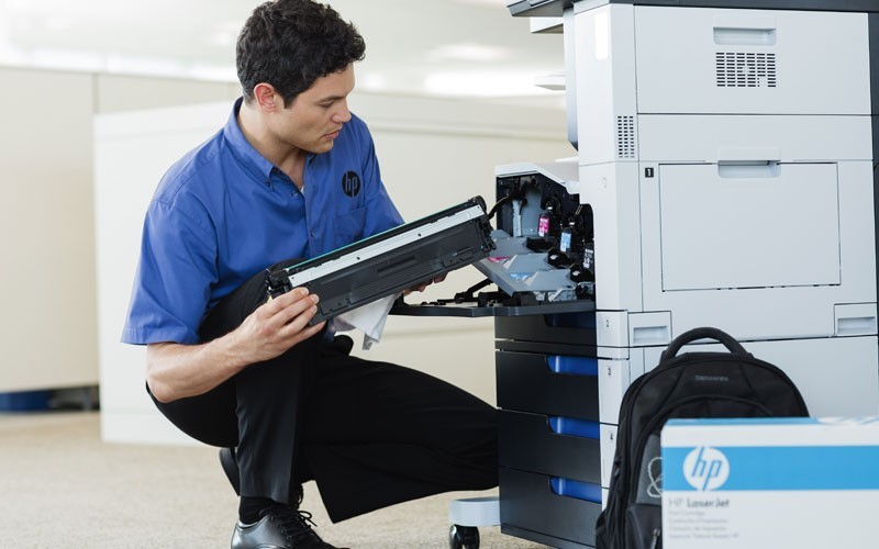 HP print efficiency assessment HP man working on printer HP Managed Print Services