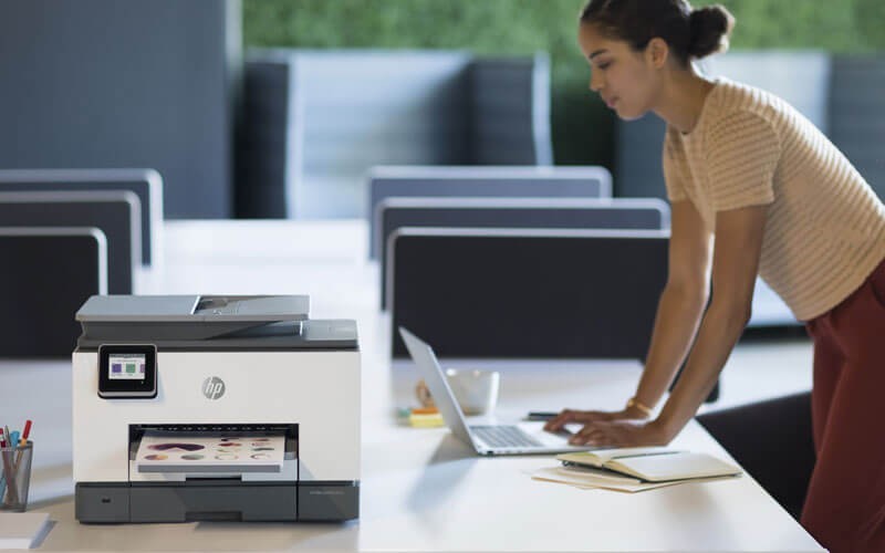 HP OfficeJet all-in-one-printers Woman using HP OfficeJet all-in-one-printer in office