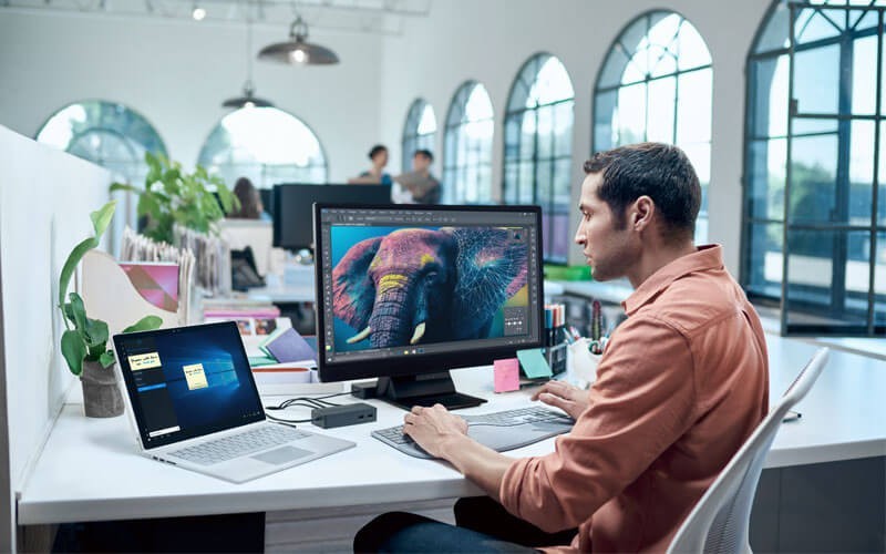 Insight Connected Workforce Solutions Microsoft designer worker on devices in open office
