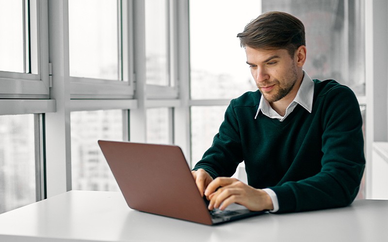Don't overspend on your subscriptions Man assessing subscription services on a laptop