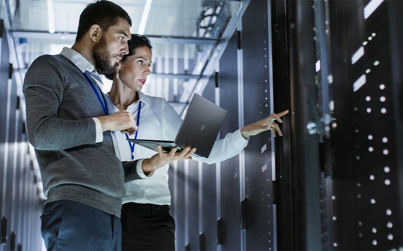 Optimise your data centre with Snow Two colleagues working in a data centre