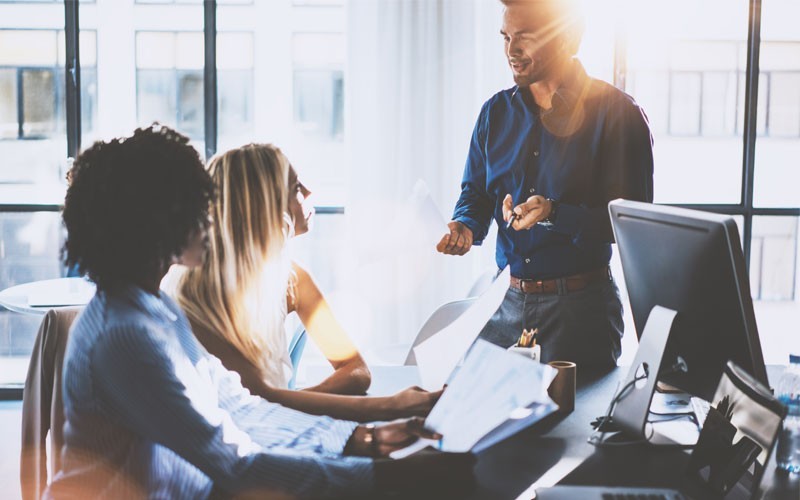 NSX Cloud you can deliver consistent cloud networking and security for apps Employees discussing together