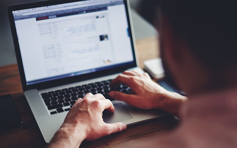 VMware can help you move forward now with Hyperconverge This! Man using a laptop